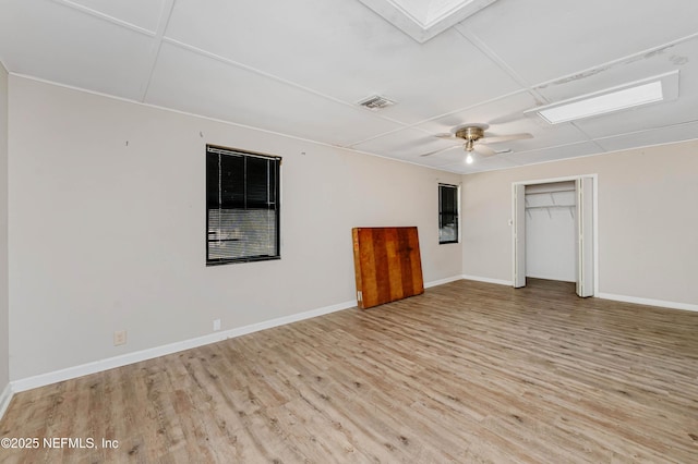 unfurnished bedroom with ceiling fan, light hardwood / wood-style floors, and a closet