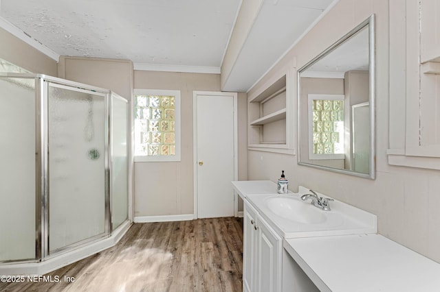 bathroom featuring crown molding, vanity, hardwood / wood-style floors, and walk in shower