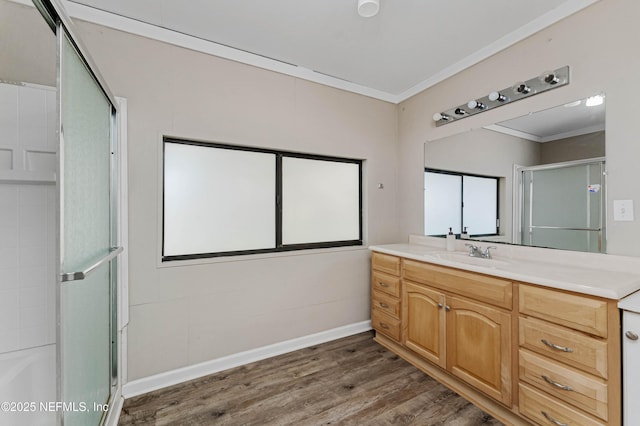 bathroom featuring crown molding, vanity, a shower with door, and hardwood / wood-style flooring