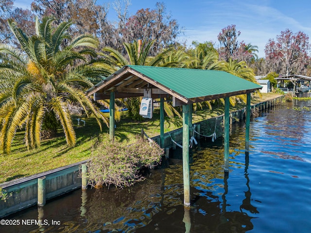 dock area with a water view and a lawn