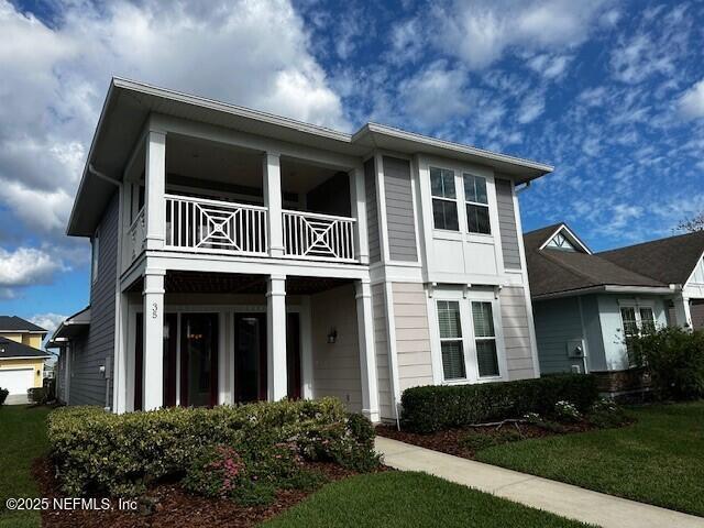 view of front of home featuring a balcony