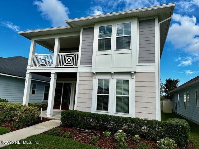 view of front of house with a porch and a balcony