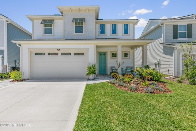 view of front of property with a garage and a front lawn