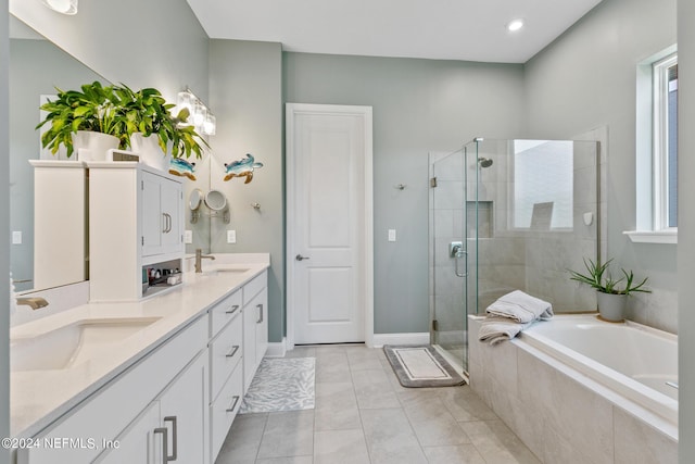 bathroom with vanity, separate shower and tub, a healthy amount of sunlight, and tile patterned floors