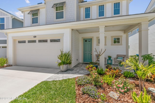 view of front of house with a garage and covered porch