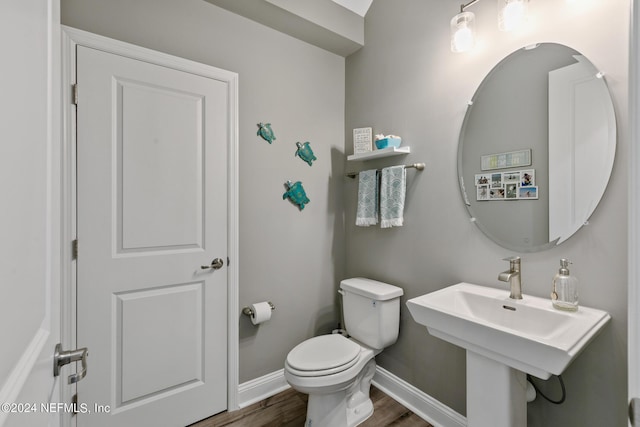 bathroom with hardwood / wood-style flooring, sink, and toilet