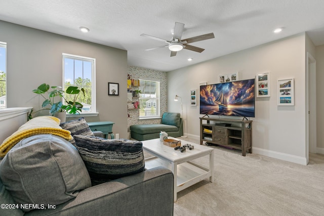 living room featuring light carpet, a textured ceiling, and ceiling fan