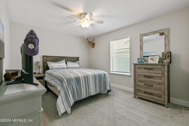 bedroom with light colored carpet and ceiling fan