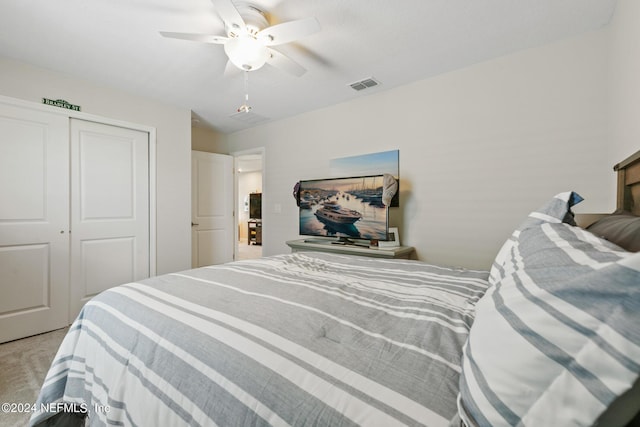 carpeted bedroom featuring a closet and ceiling fan