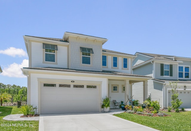 view of front of property featuring a garage and a front yard