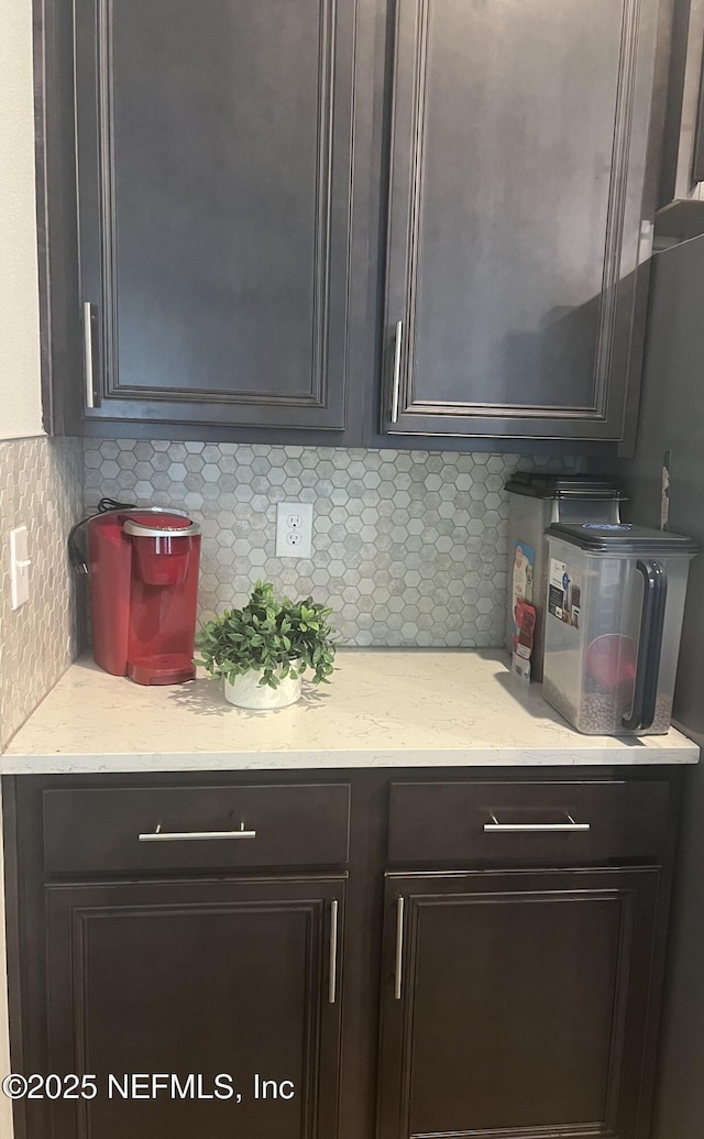 kitchen featuring light stone counters and decorative backsplash