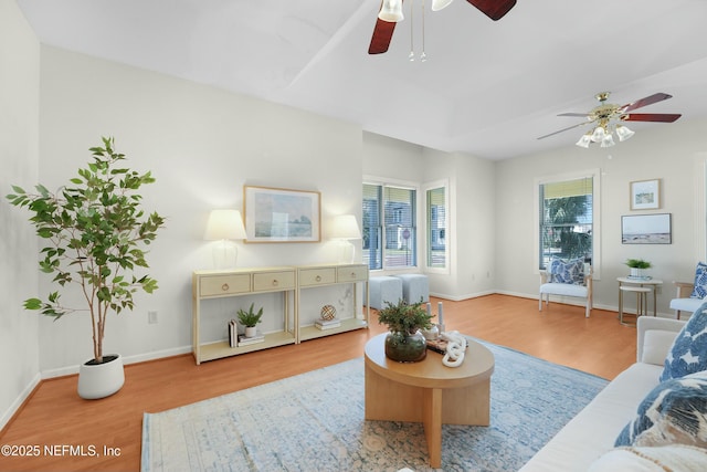 living room with ceiling fan and light hardwood / wood-style floors