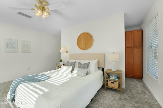 bedroom with ceiling fan and light carpet