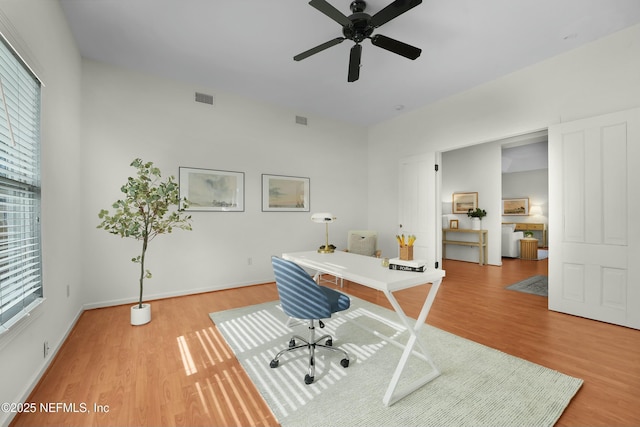 office with hardwood / wood-style flooring and ceiling fan