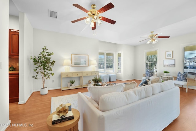 living room featuring ceiling fan and light wood-type flooring