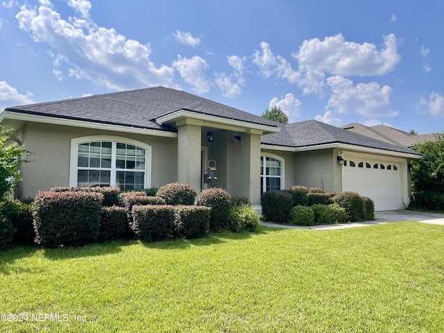 view of front of house with a garage and a front yard