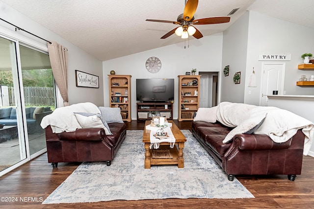 living room with vaulted ceiling, dark hardwood / wood-style floors, ceiling fan, and a textured ceiling