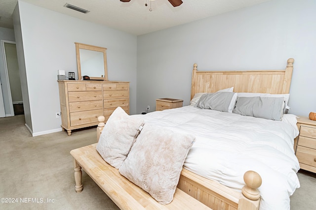 bedroom featuring ceiling fan and light carpet