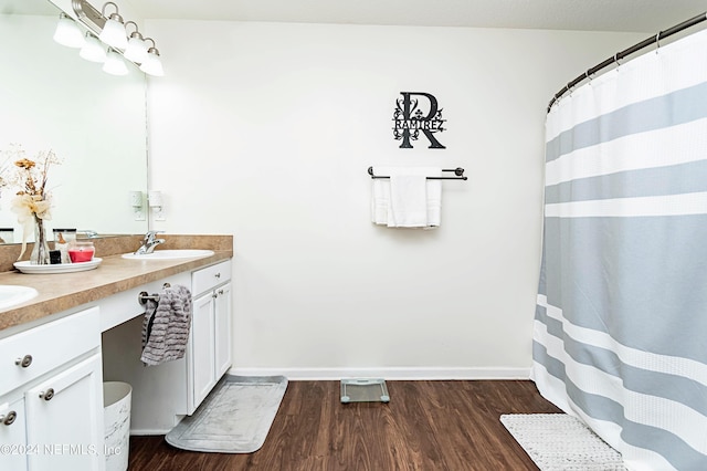 bathroom with vanity and wood-type flooring