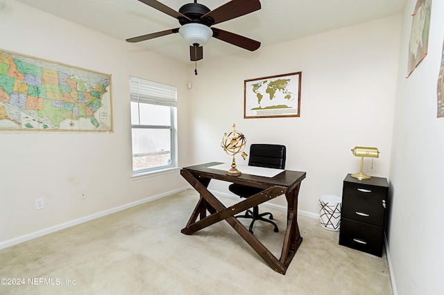 carpeted office space with ceiling fan