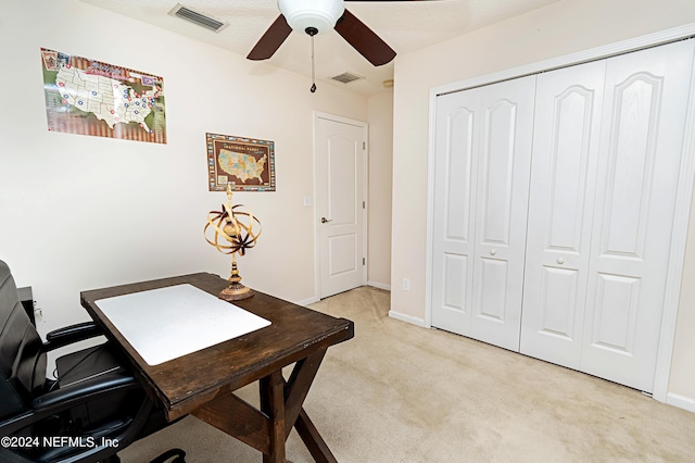 home office with ceiling fan and light carpet