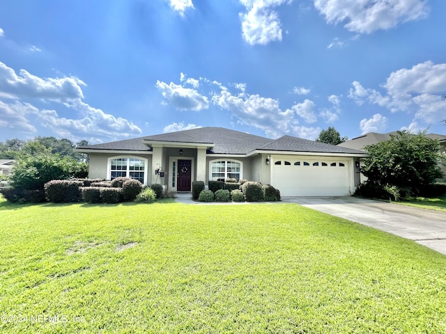 view of front of property featuring a garage and a front yard