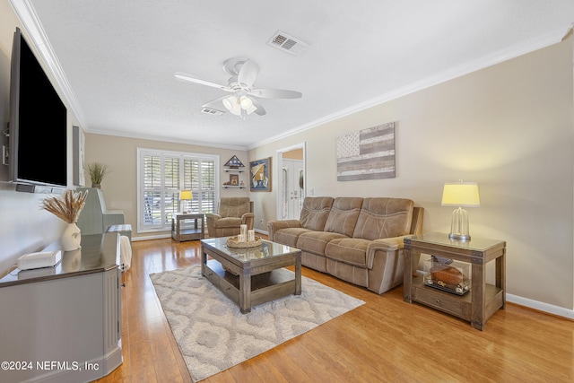 living room with ornamental molding, ceiling fan, and light hardwood / wood-style flooring