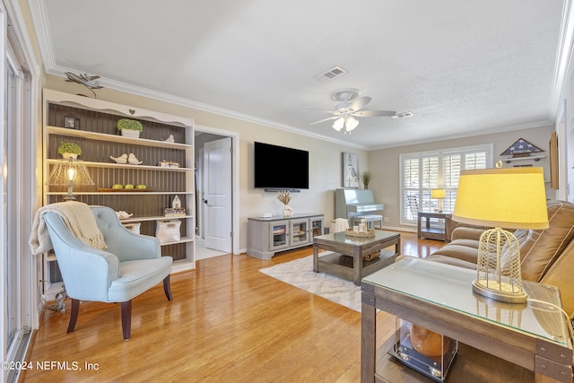 living room featuring crown molding, a textured ceiling, ceiling fan, and light wood-type flooring