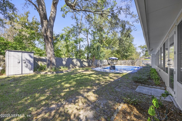 view of yard with a shed and a fenced in pool