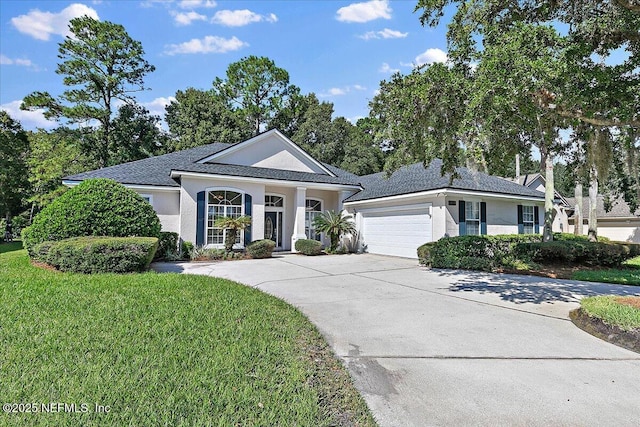 view of front of house with a garage and a front lawn