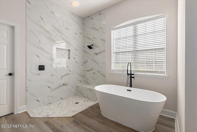 bathroom with independent shower and bath and wood-type flooring