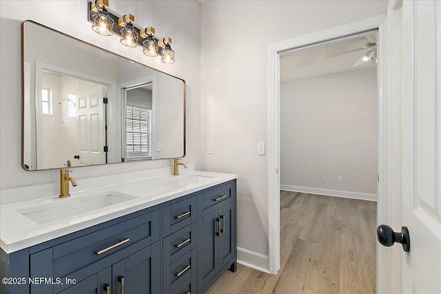 bathroom featuring vanity, hardwood / wood-style floors, and ceiling fan