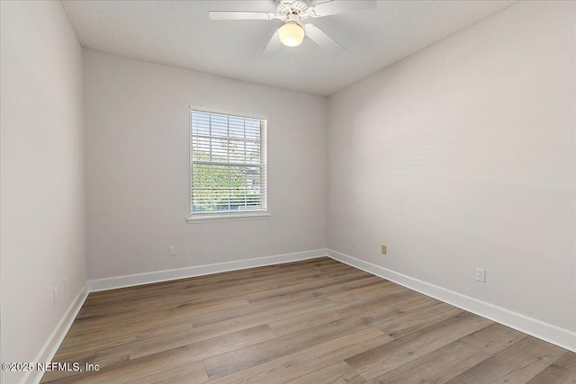 unfurnished room with ceiling fan and light wood-type flooring