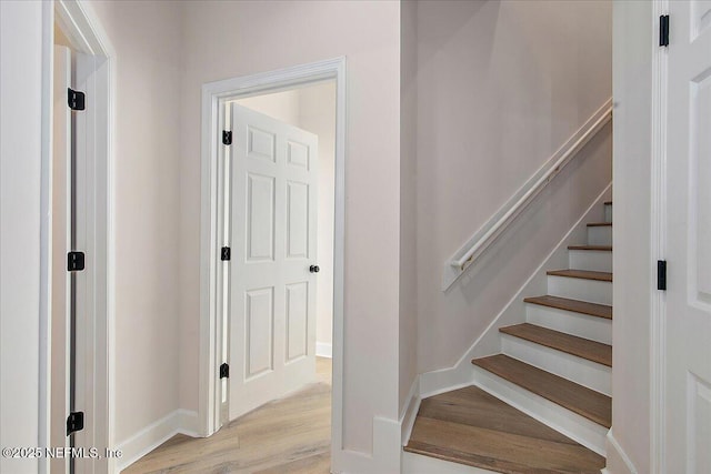 stairway featuring wood-type flooring