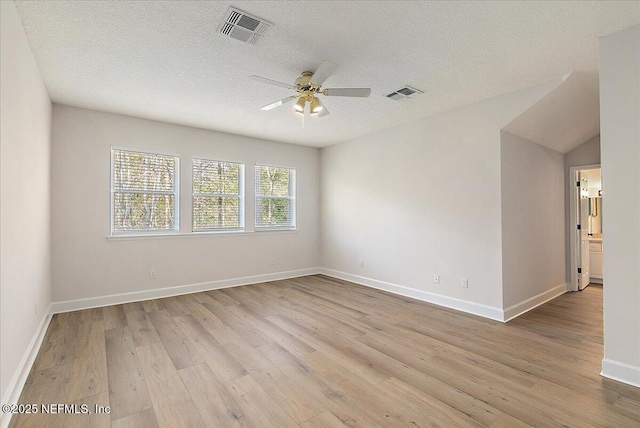 unfurnished room featuring ceiling fan, a textured ceiling, and light wood-type flooring