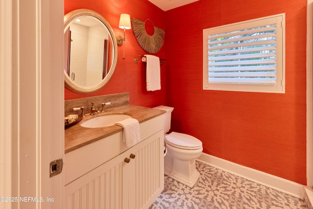 bathroom with tile patterned flooring, vanity, and toilet