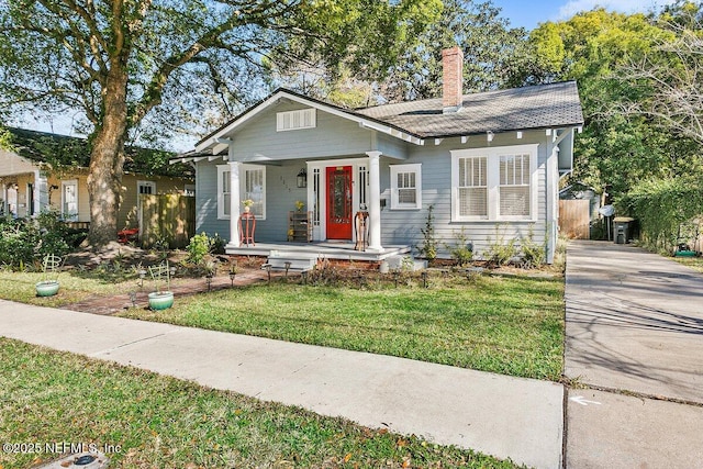 view of front of home with a porch and a front yard