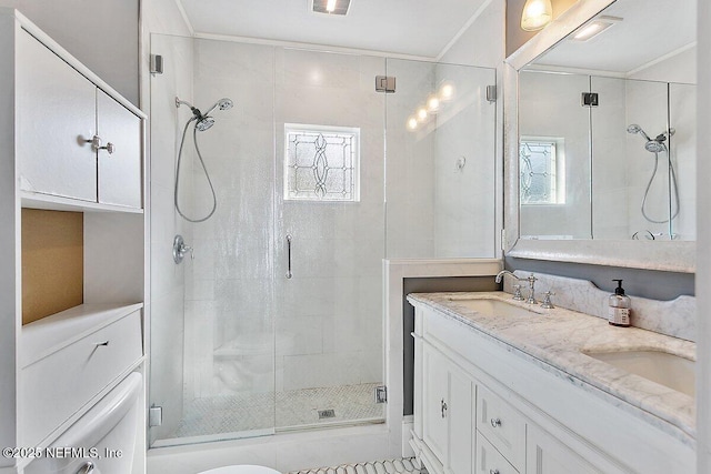 bathroom featuring ornamental molding, vanity, and a shower with door