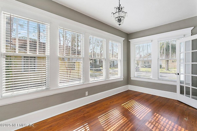 unfurnished sunroom with an inviting chandelier