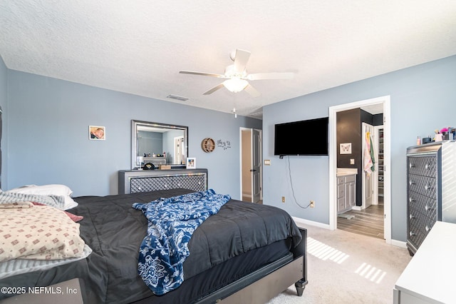 carpeted bedroom featuring ceiling fan and a textured ceiling