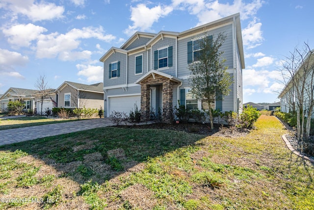 view of front of home featuring a garage and a front yard