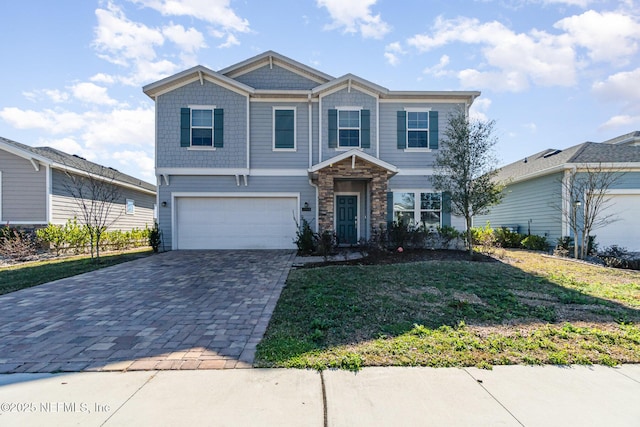 view of front of home featuring a garage and a front yard