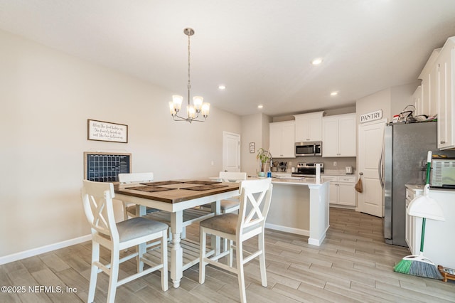 dining space with a notable chandelier