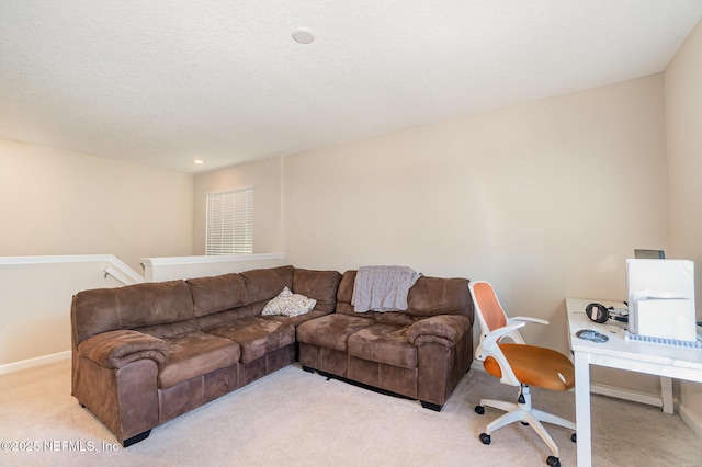 carpeted living room featuring a textured ceiling