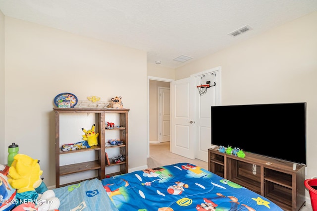 carpeted bedroom with a textured ceiling