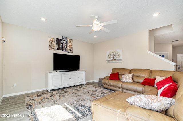 living room featuring ceiling fan and light wood-type flooring