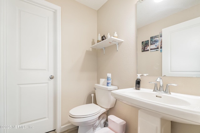 bathroom featuring sink and toilet