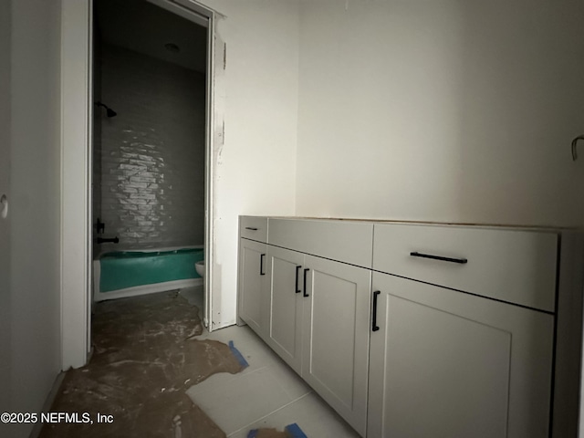 bathroom featuring toilet, tub / shower combination, and concrete flooring