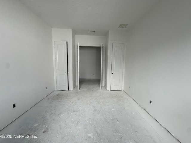 unfurnished bedroom featuring a closet and a textured ceiling