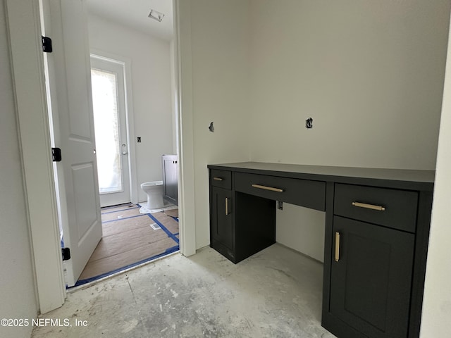 bathroom with concrete floors and toilet